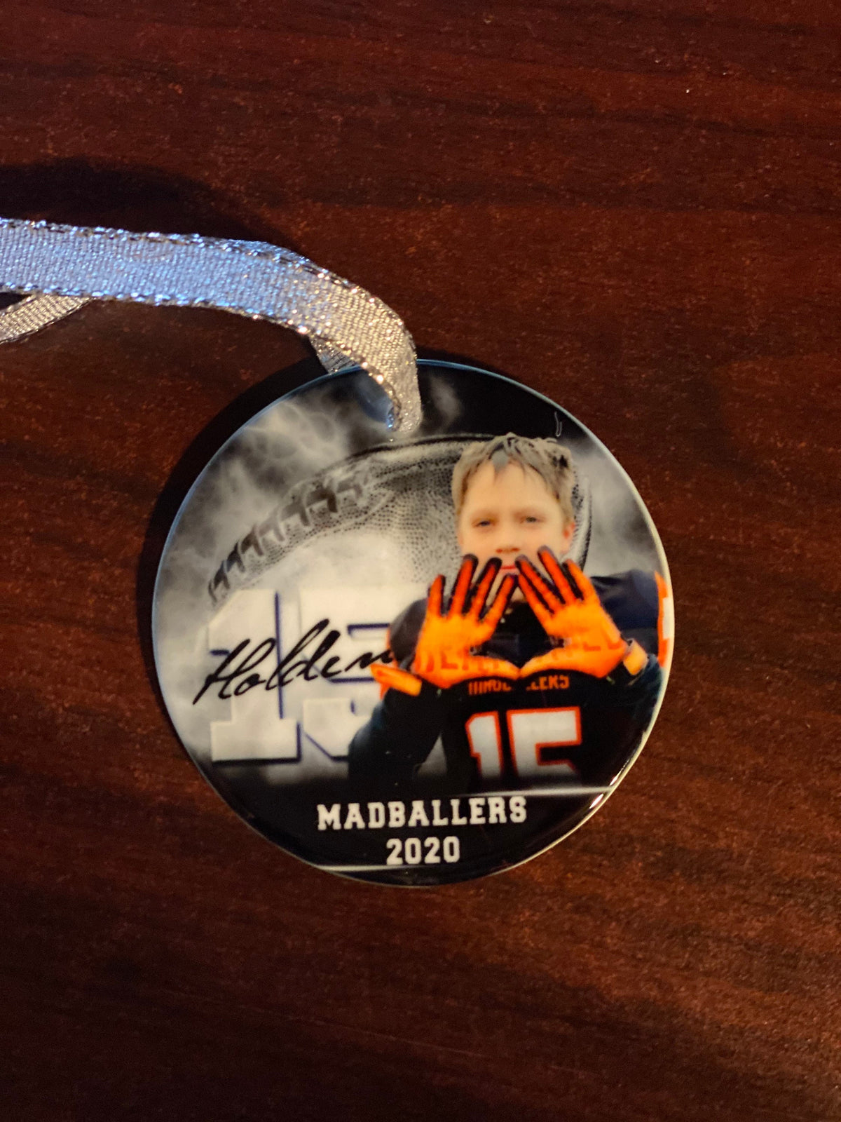 Customized football ornament. Great for senior who committed or for teams end of season gift. Can be personalized with 2 different picture.